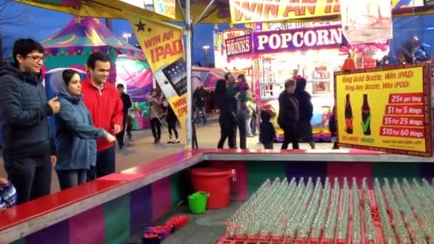 Carnival game of throwing rings over bottle necks at the West Coast Amusements Carnival — Stock Video