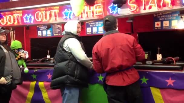 People playing shooting game at the West Coast Amusements Carnival — Stock Video