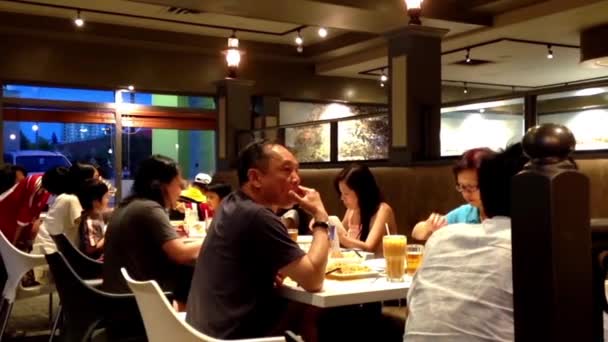 People eating food at Chinese restaurant at night — Stock Video