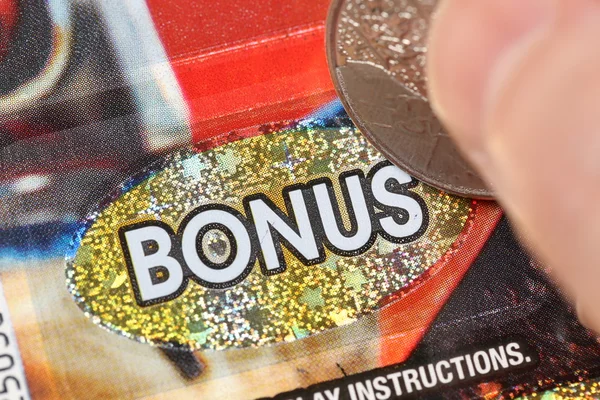 Close up woman scratching lottery ticket — Stock Photo, Image