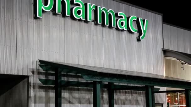 Pharmacy sign on building at night scene — Stock Video