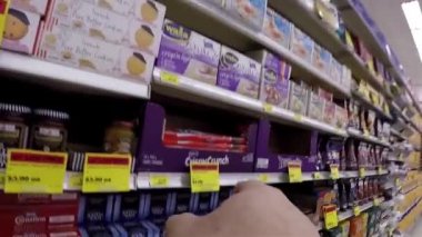 Hand pointing serial about picking chocolate with wide angle camera shot