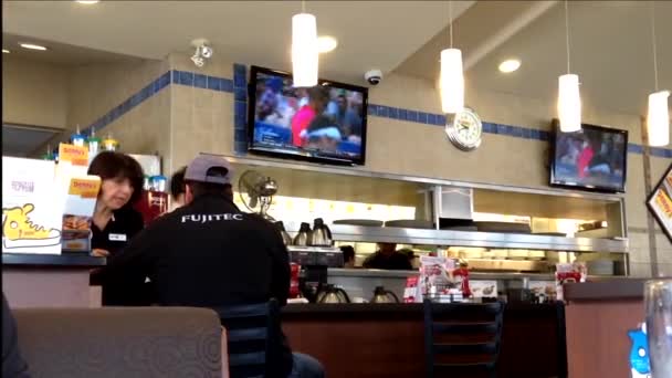 People ordering food inside Denny's restaurant in Coquitlam BC Canada. — Stock Video