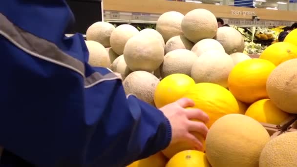 Man selecting oriental melon in grocery store produce department. — Stock Video