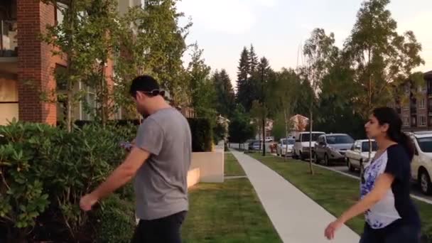 People take a walk passing through new apartment entrance — Stock Video