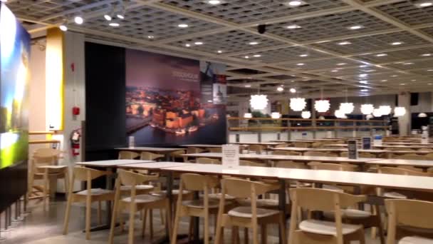 Dolly shot of empty food court cafeteria inside Ikea store — Stock Video