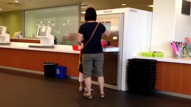 One side of return book section in Coquitlam Public Libray. — Stock Video