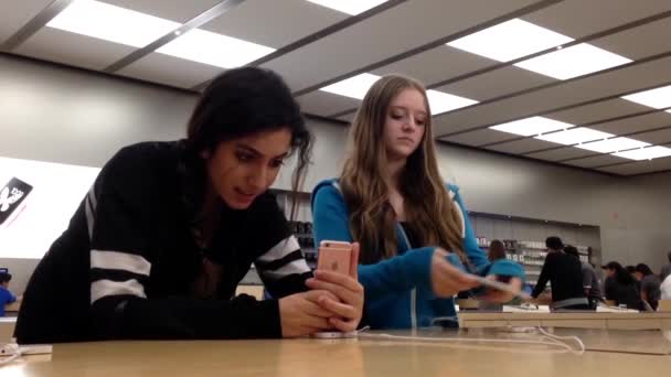 Woman playing new iphone 6s inside Apple store at first day starting sell. — Stock Video