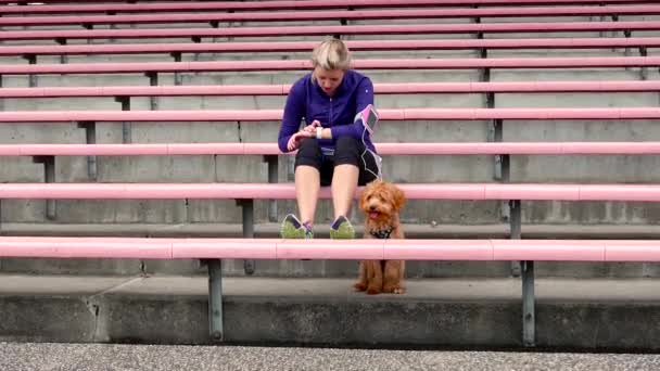 Frau und Hund ruhen im Stadion — Stockvideo