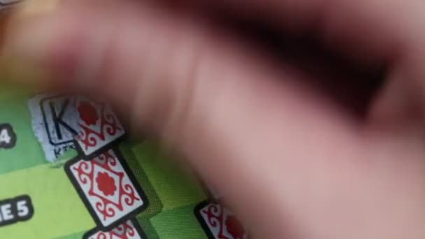 Close up woman scratching lottery ticket. — Stock Video