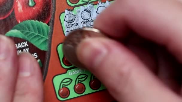 Close up woman scratching lottery ticket — Stock Video