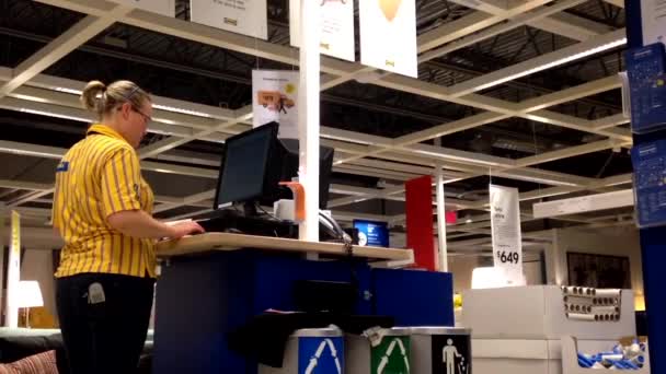 Female worker at information station checking some data — Stock Video