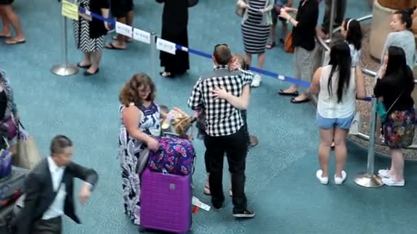 Kvinnan kramar hennes vän på internationella ankomst lobbyn i Vancouver Bc Kanada. — Stockvideo