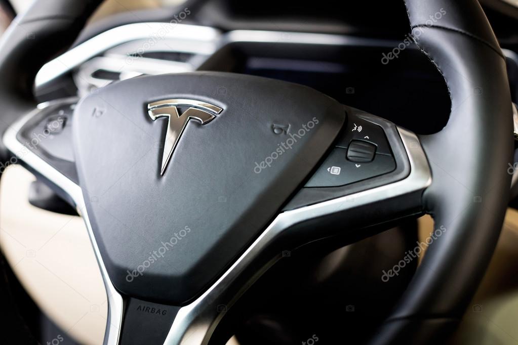 Tesla logo on the steering wheel inside car