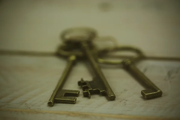 Alte Schlüssel auf rustikalem Hintergrund — Stockfoto
