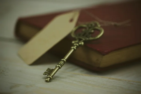 Old keys and book on a rustic background — Stock Photo, Image