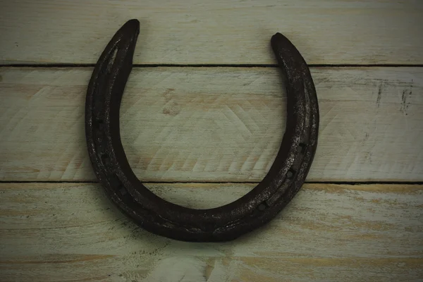 Horseshoe on a wooden background