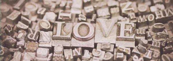 Close up of typeset letters with the word Love — Stock Photo, Image