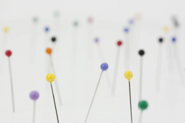 Different coloured pins on a light background