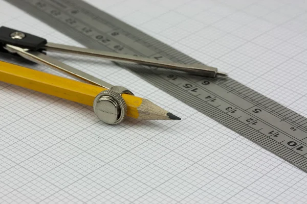 Compass and ruler on graph paper — Stock Photo, Image