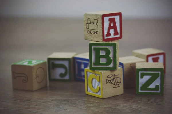 Childrens blocks on a wooden floor Stock Photo