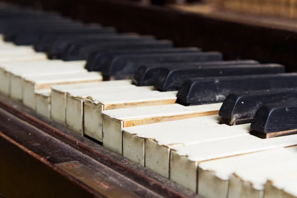 Old broken disused piano with damaged keys — Stock Photo, Image