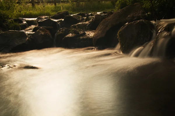 Cascada en un pequeño arroyo rural. Larga exposición . —  Fotos de Stock