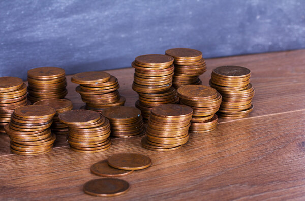 Stack of penny coins on a wooden surface