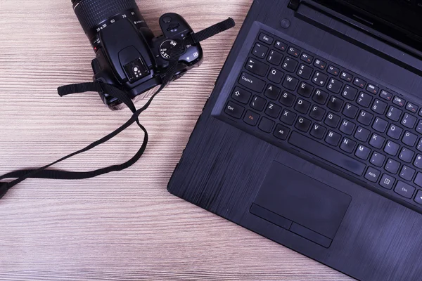 Lay flat image of a laptop and camera