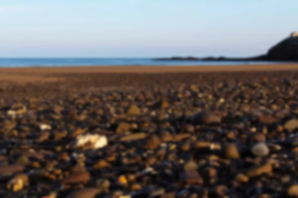 Pebbles on the seafront at Bude, Cornwall Out of focus. — Stock Photo, Image