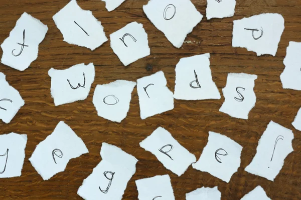 Torn letters against wood background — Stock Photo, Image