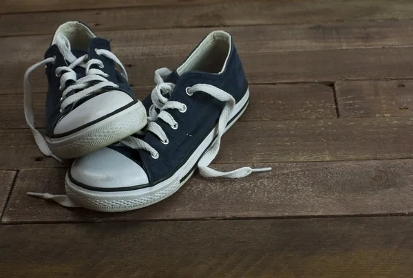 Old shoes on a wooden floor — Stock Photo, Image