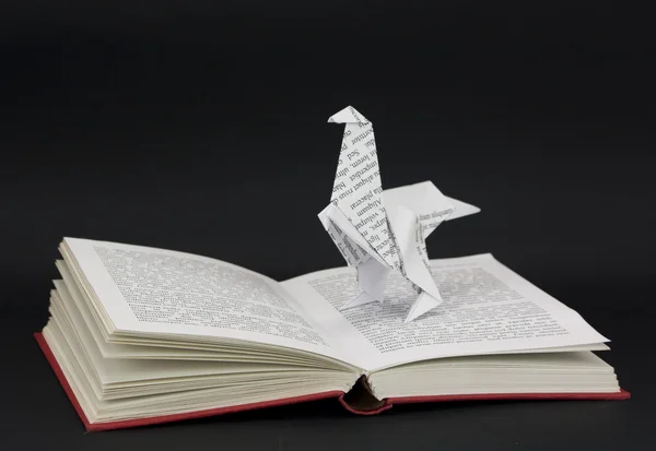 Origami dinosaur coming out of a book — Stock Photo, Image