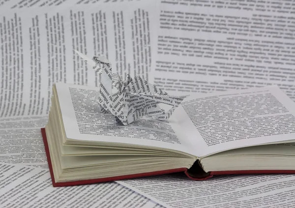Origami dragon coming out of a book — Stock Photo, Image