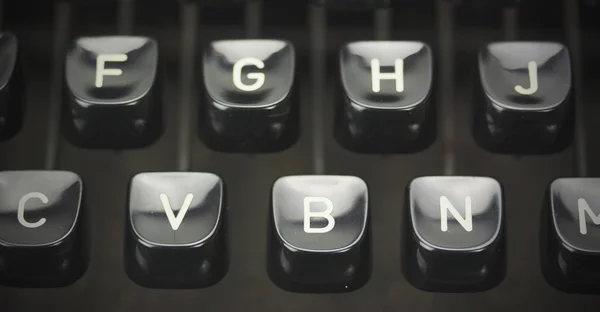 Close up of lettered keys on an old typewriter. Vintage filter a — Stock Photo, Image