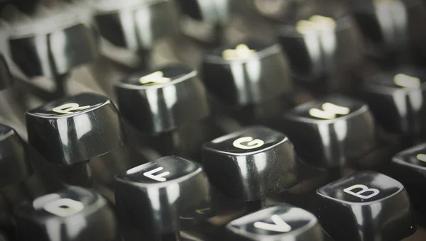 Close up of lettered keys on an old typewriter. Vintage filter a — Stock Photo, Image
