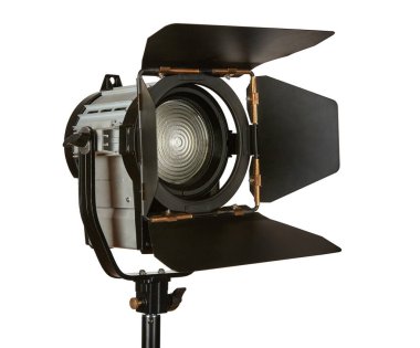 Constant light illuminator with curtains and fresnel lens on a stand for filming movies. The device is isolated on a white background. clipart