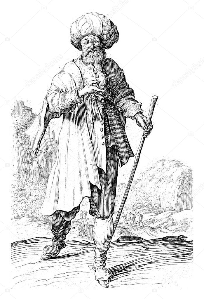 A man in oriental clothing with a turban on his head and a walking stick in his hand. In the background a hilly landscape and a number of figures.