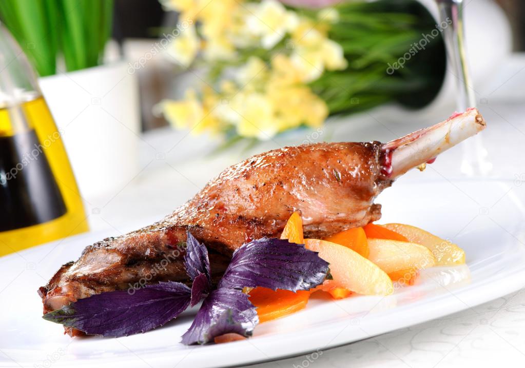 Baked goose leg with pear