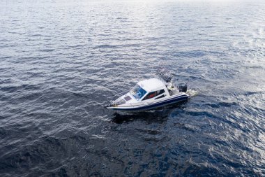 Okyanusta teknede hava manzaralı balıkçı. Balıkçı teknesiyle güzel bir deniz manzarası. Balıkçıyla hava manzaralı balıkçı teknesi. Okyanus suyu dalgası yansımaları. Okyanusta motorlu tekne.