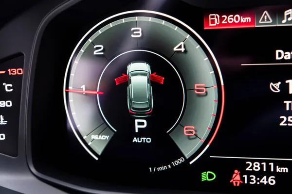 Close up shot of a digital tachometer in car. Fully digital car dashboard. Dashboard details with indication lamps. Car instrument panel.