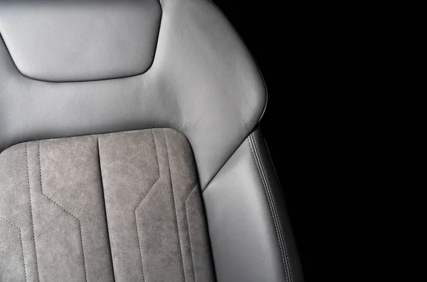 Modern luxury car black leather with alcantara interior. Part of black leather car seat details with white stitching. Interior of prestige car. Perforated leather seats isolated. Perforated leather.