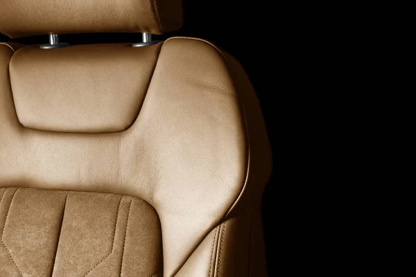 Modern luxury car brown leather with alcantara interior. Part of orange leather car seat details with white stitching. Interior of prestige car. Perforated leather seats isolated. Perforated leather.