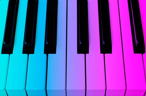 Top view of piano keys in blue and pink tones . Close-up of piano keys. Close frontal view. Piano keyboard with selective focus.  Piano keyboard perspective