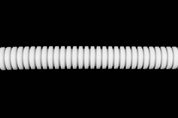 Plastic corrugated pipe tube for electrical installation close-up. Corrugated pipe isolated on black background.