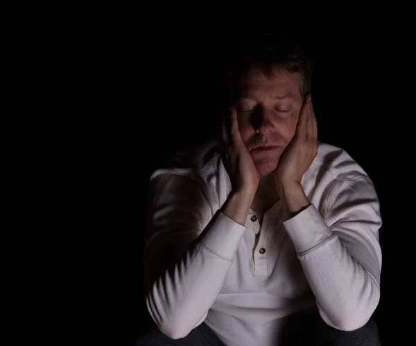 Tired man showing depression in dark background — Stock Photo, Image