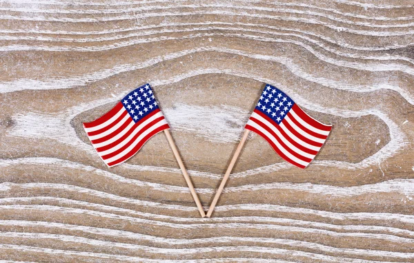 Small USA flags on white rustic wooden boards