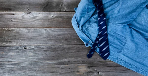 Blue shirt and necktie on vintage wooden planks for Fathers Day Concept