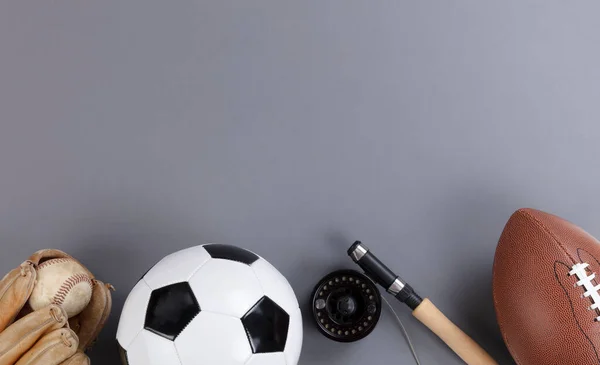 Fathers day concept with a variety of sports equipment on a gray background in flat lay format