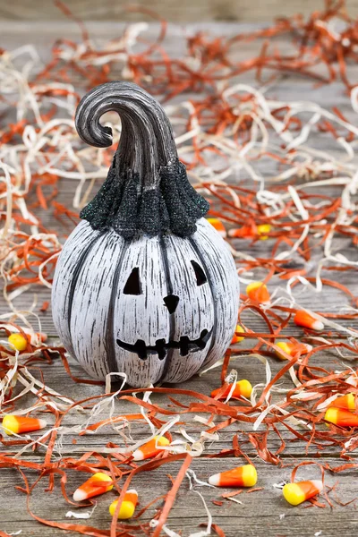 Scary black and white Halloween pumpkin on rustic wood — Stock Photo, Image